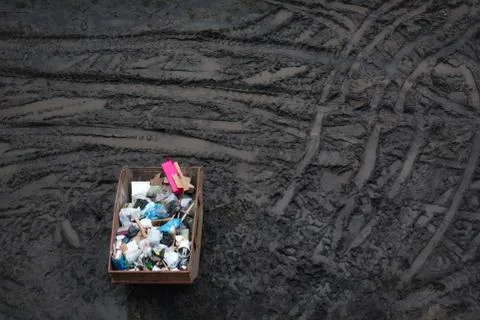 Trash in a large container, top view, dirt background Stock Photos