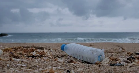 Trash, plastic, garbage, bottle... environmental pollution on the beach Stock Footage 100411472