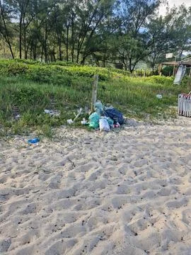 Trash on a sandy beach Stock Photos