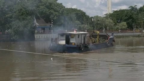 Trash skimmer boat doing maneuvers on the Martapura river, Banjarmasin Stock Footage 156993659