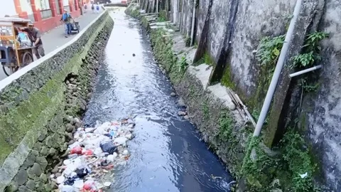 For Trash at Small River, condet East Jakarta, Indonesia, some people Passing by Stock Footage 202313490