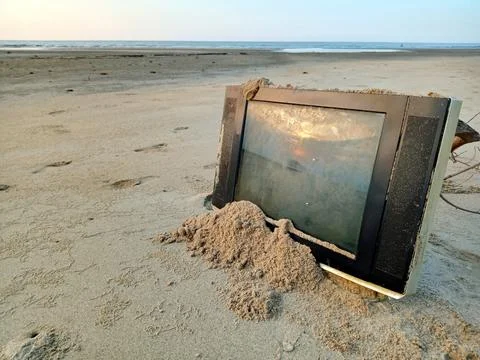 Trash from a television on the beach Stock Photos