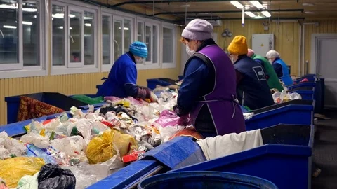 Trash workers sorting trash, garbage at a recycling plant conveyor Stock Footage 72707659