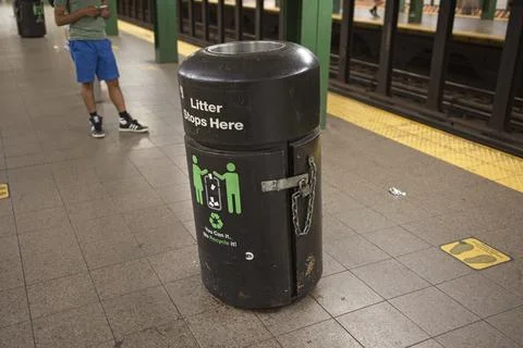 Trashcan on subway platform 스톡 사진