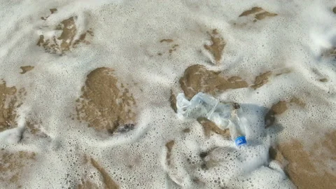 Trashed plastic bottle float over sea waves ecosystem,environment pollution 4k Stock Footage 230738157