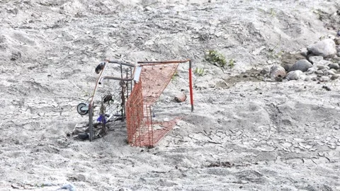 Trashed Shopping Cart In Riverbed Sand Stock Footage 333018829