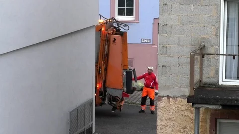 Trashman empties trash can into garbage truck, waste collection, garbage man 库存影片 89912876
