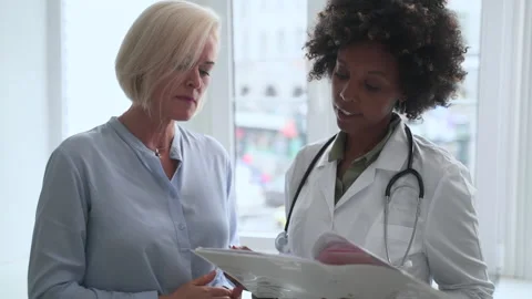 Traumatologist and lady client discuss test results at visit Stock Footage 164272744
