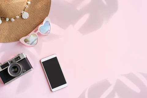 Travel accessories items with empty screen smart phone and retro camera on co Fotos Stock