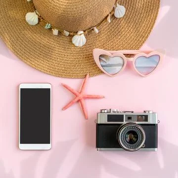 Travel accessories items with empty screen smart phone and retro camera on co 写真素材