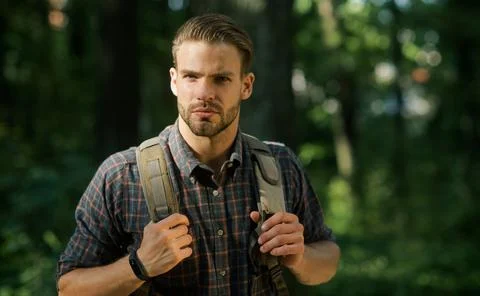 Travel, adventure, vacation. Man with backpack hiking in woods. Bearded hipst Stock Photos