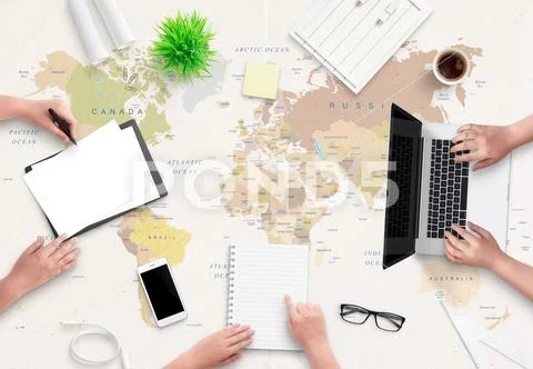 Travel agency office concept. People work with papers and a computer. World m Stock Photos