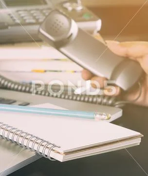 Travel agency staff is taking call for flight booking Stock Photos