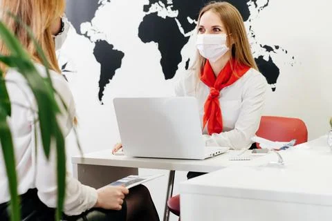 Travel agent working with client in light modern office of tour agency, Stock Photos