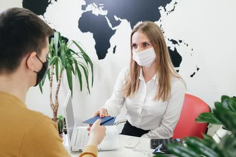 Travel agent working with client in light modern office of tour agency, Stock Photos