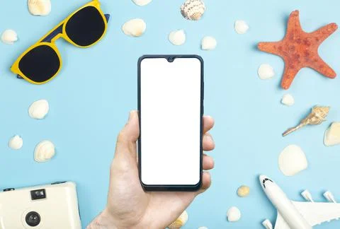 Travel app concept. Empty screen smartphone on a colored background with trav Stock Photos