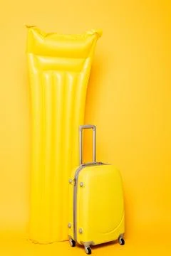Travel bag pool float yellow Stock Photos