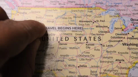 Travel Begins Here paper label on map of United States for vacation planning Stock Footage 346574852