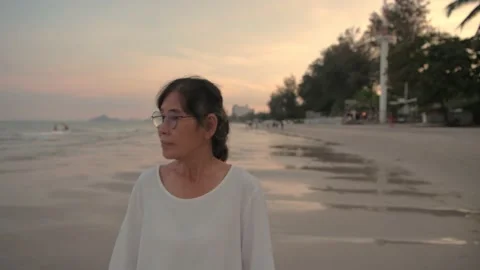 Travel concept of 4k Resolution. An old woman walking on the beach. Stock Footage 151887852