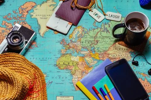 Travel concept background with a retro camera a cup of tea, a hat, a note boo Stock Photos