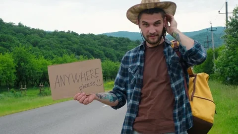 Travel Concept. Guy tries to stop car, asks for help with thumbs up. Stock Footage 243452977