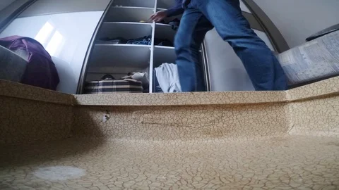 Travel concept of man sorting and packing his clothes into suitcase 스톡 동영상 97835284
