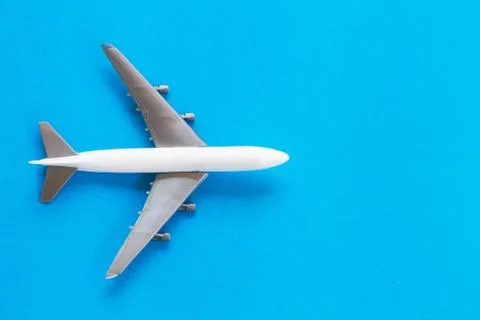 Travel concept using a plane on a blue background. Stock Photos