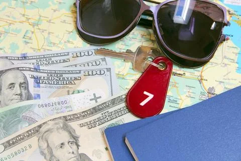 Travel context with sunglasses money map hotel room key and passports Foto stock