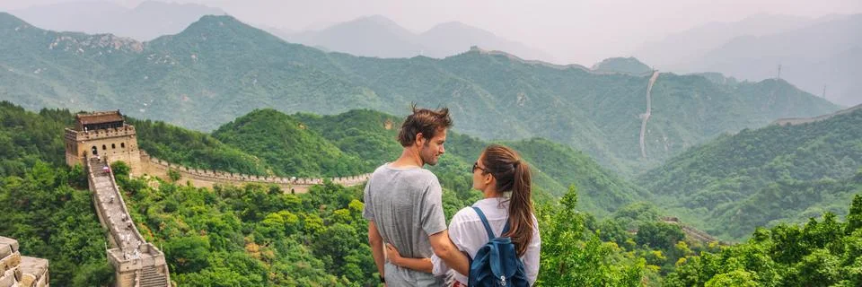 Travel couple China tourists at view of Great wall mountains landscape. Happy Stock Photos