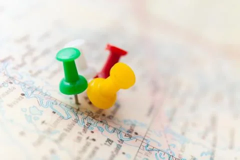 Travel destination points on a map indicated with colorful thumbtacks and Stock Photos