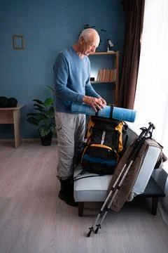 Travel. Elderly man packing backpack to hike travel. tourism,vacation and hiking Stock Photos