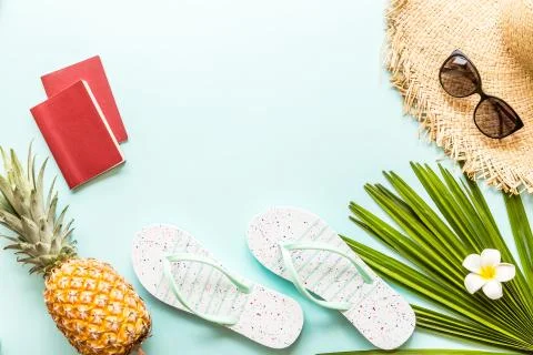Travel flat lay items: two passports, fresh pineapple, sunglasses Stock-Fotos