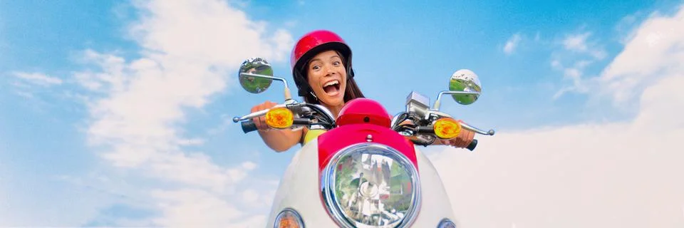 Travel fun funny tourist carefree driving scooter on summer road trip. Screaming Stock Photos