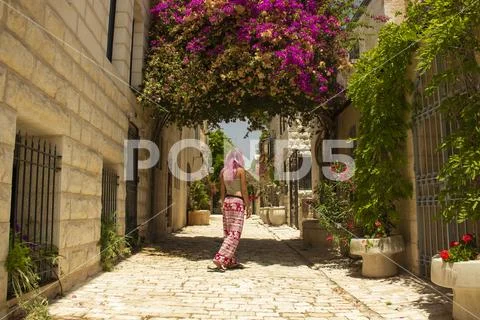 Travel girl back to camera walking in holy land Jerusalem Israeli old street Stock Photos