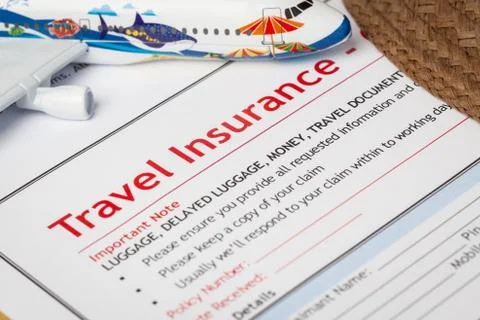 Travel Insurance Claim application form and hat with eyeglass on brown envelo Stock Photos