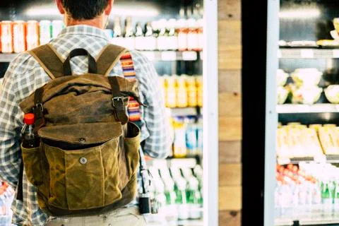 Travel man viewed from back in front of an automatic drink store choosing sna Stock Photos