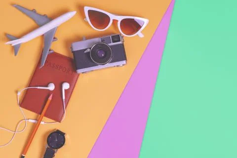 Travel objects and accessories on orange green purple  background with passpo Stock Photos