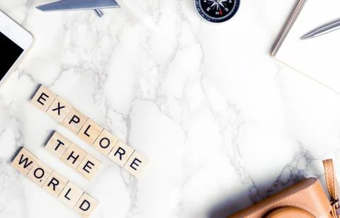 Travel objects with explore the world text on marble copyspace Фото