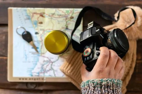 Travel planning with map and camera on rustic table Stock Photos