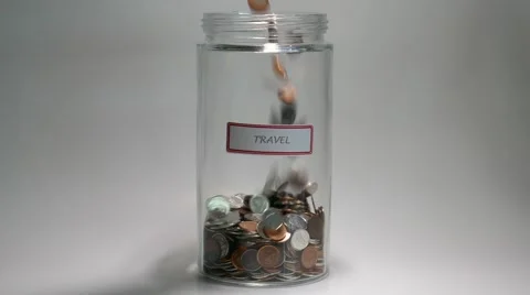 Travel Savings Jar filled with coins Stock Footage