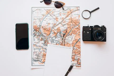 Travel set: map, sunglasses, camera, notebook, pen, phone, magnifier Stock Photos
