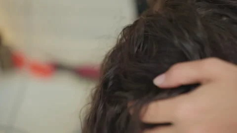 Travel styling routine. Closeup of hands using hot air dryer on curly hair Stock-Footage 345136971