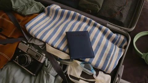Travel Suitcase Packed with Passport, Camera Family Vacation Essentials Stock Footage 336653532