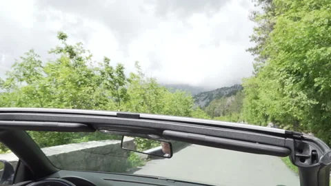 Travel tourism concept. Rear view mirror reflection of young man who drive Stock Footage 130652653