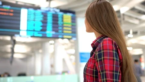 Travel woman using smartphone at airport. Young caucasian traveler checking Stock Footage