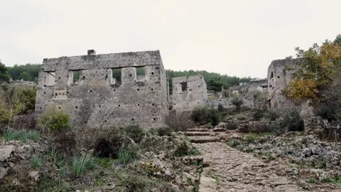 Traveler with Backpack Exploring the Abandoned Ruins of Kayaköy Ghost Village, F Video stock 294092583