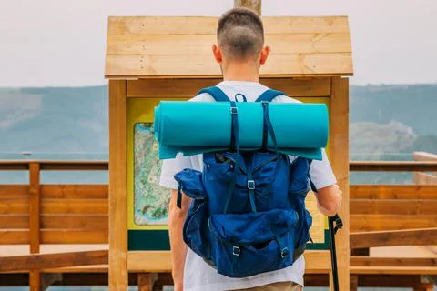Traveler with backpack looking at the map Stock Photos