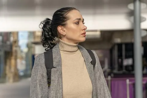 Traveler with a backpack waiting for a train at the train station. Woman mi.. Stock Photos
