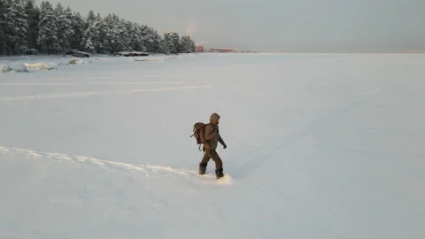 A traveler with a backpack walks through deep snow Video stock 167603665