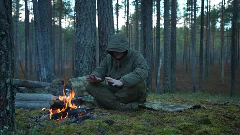 Traveler by a campfire in the forest Video stock 296283785